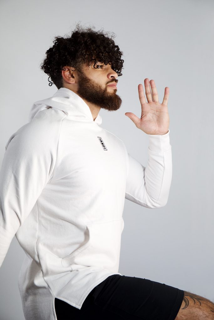 Cory Wharton wearing 1and1 TDC Unisex Hoodie in True White.