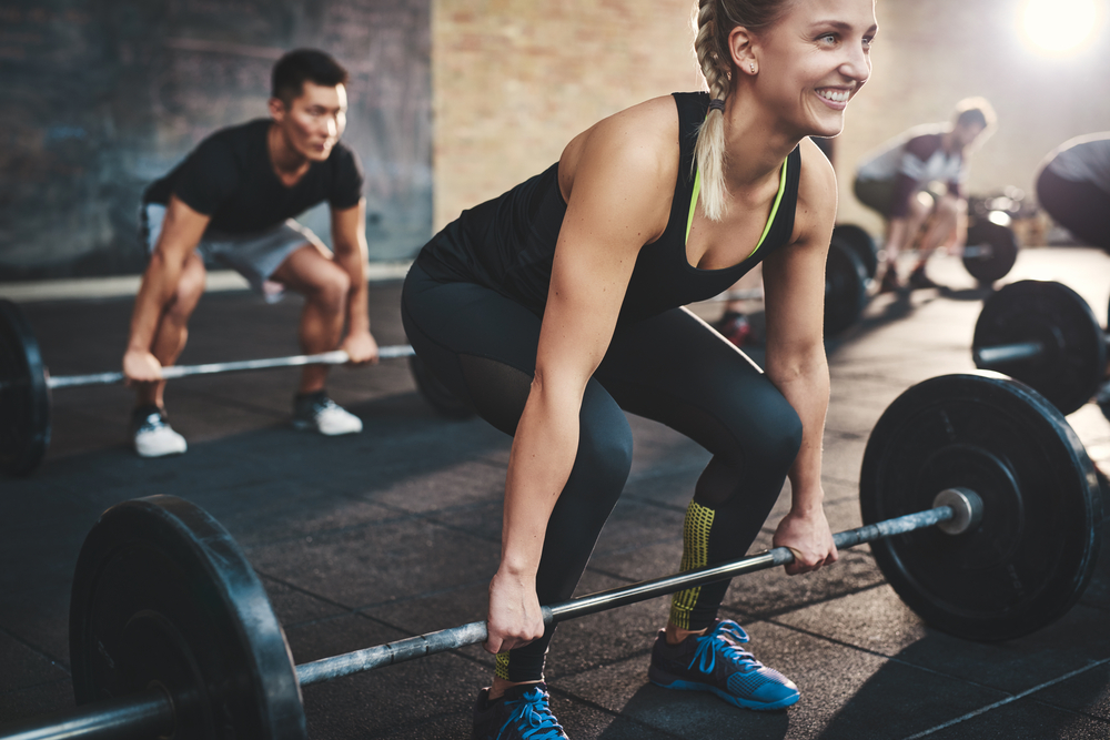 People lifting weights in the gym as part of the 6 week challenge.