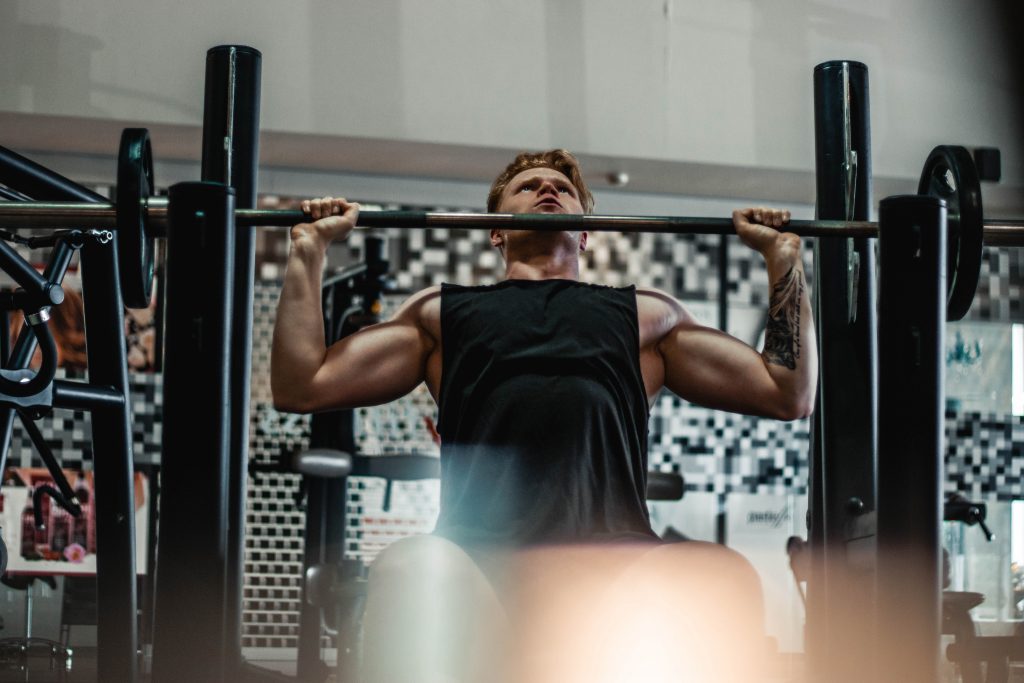 A man lifting trying to increase bench press.
