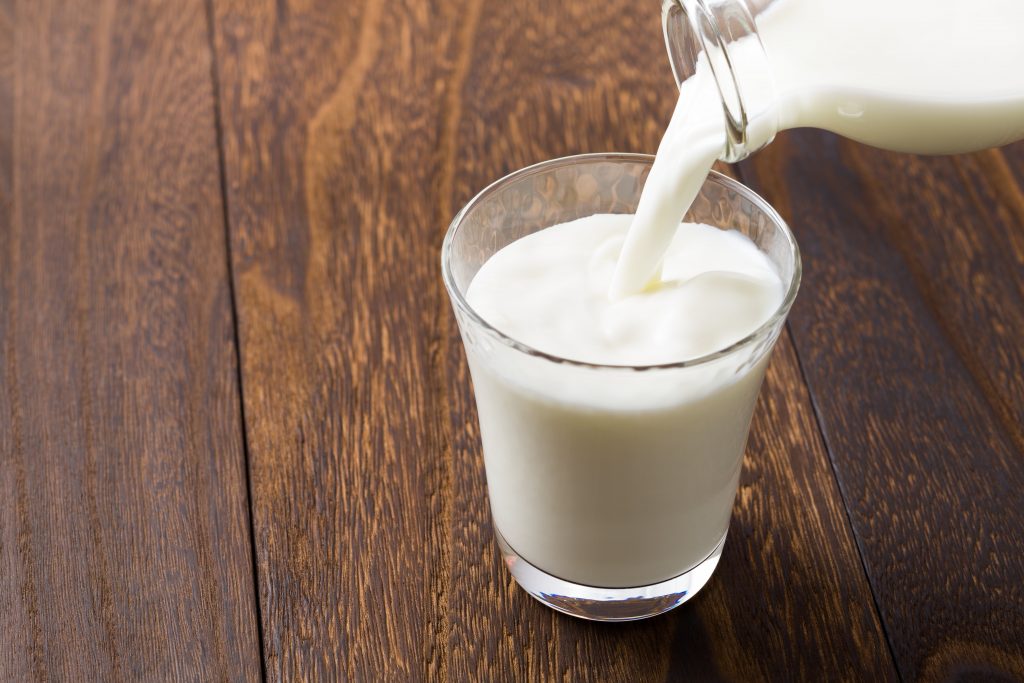 Pouring milk into a glass. Is milk good or bad for you?