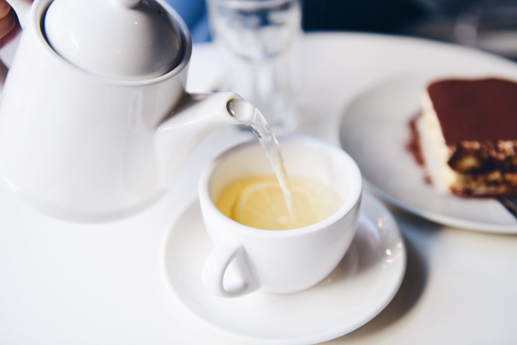 Pouring a lemon tea in a cup.