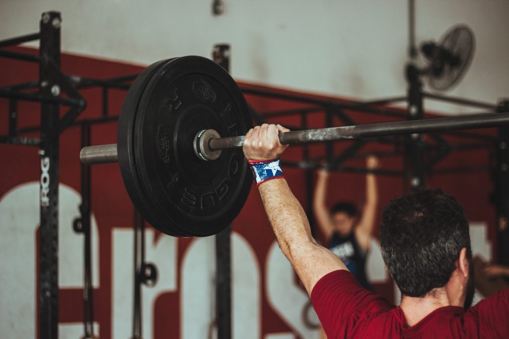 Man doing dead lifting needs to have a pre workout supplements.
