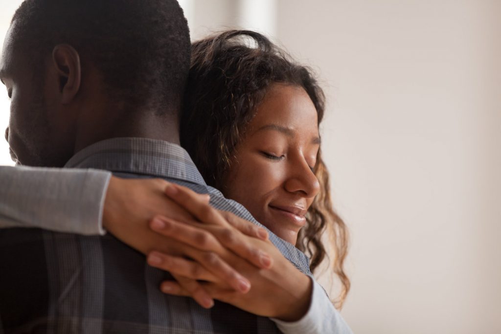 Young african american couple embracing each other.