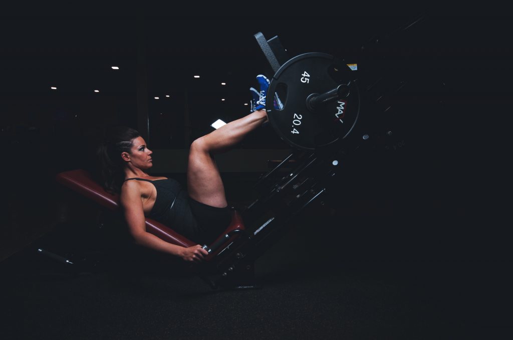 Doing leg press exercises is an effective leg day workout for women.