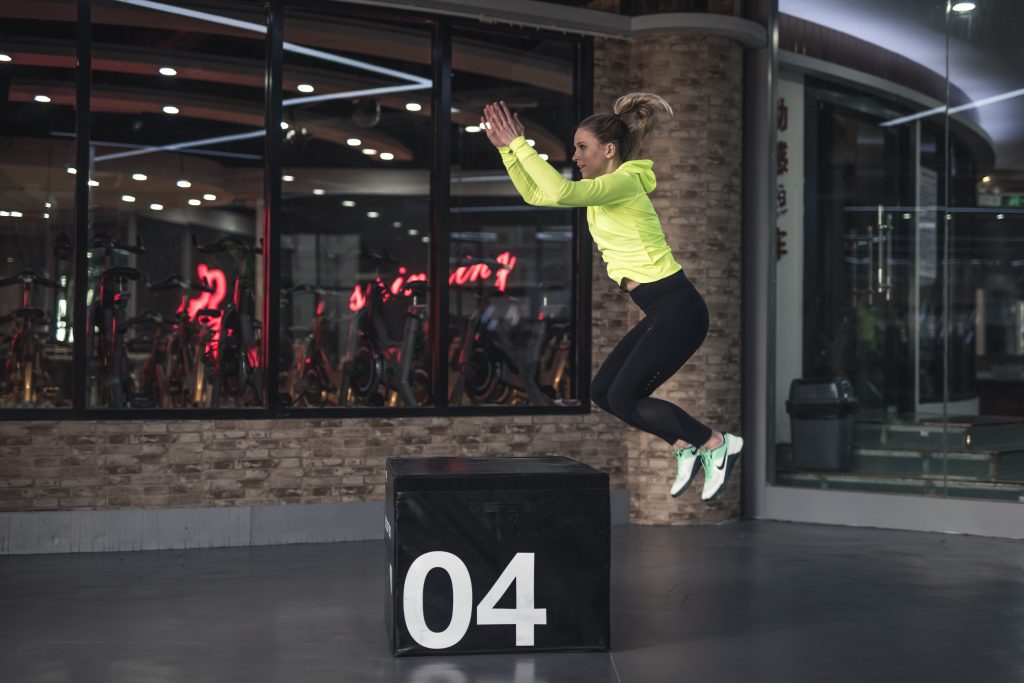 Woman doing squat jump.
