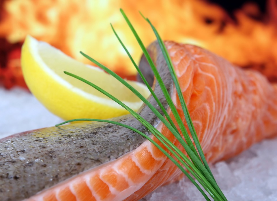 Fresh salmon with lemon on an ice.