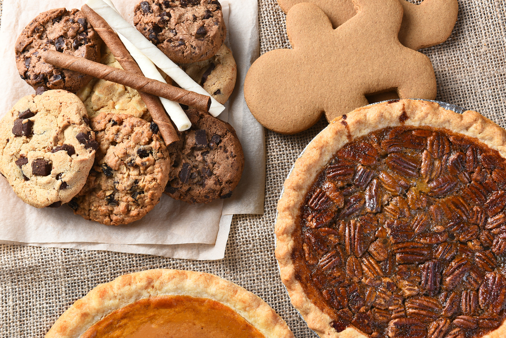 Close up of cookies and pie on a table.