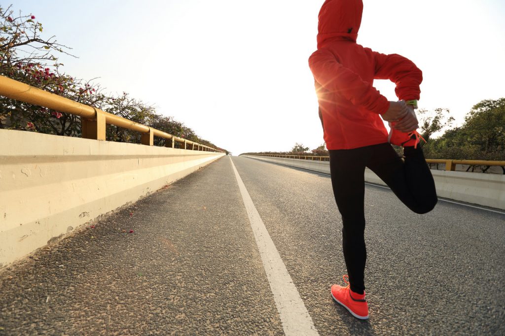 Woman stretching legs and calves before running.