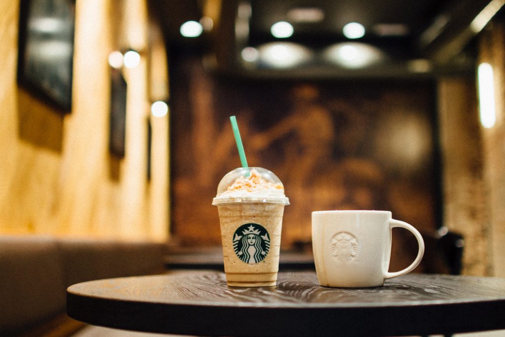 Starbucks blended beverage and a mug on top of table. How unhealthy are they?