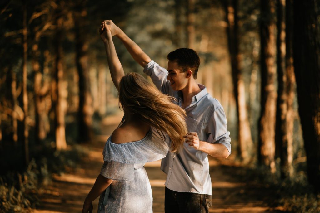 Couple dancing in the woods as an exercise to reduce anxiety