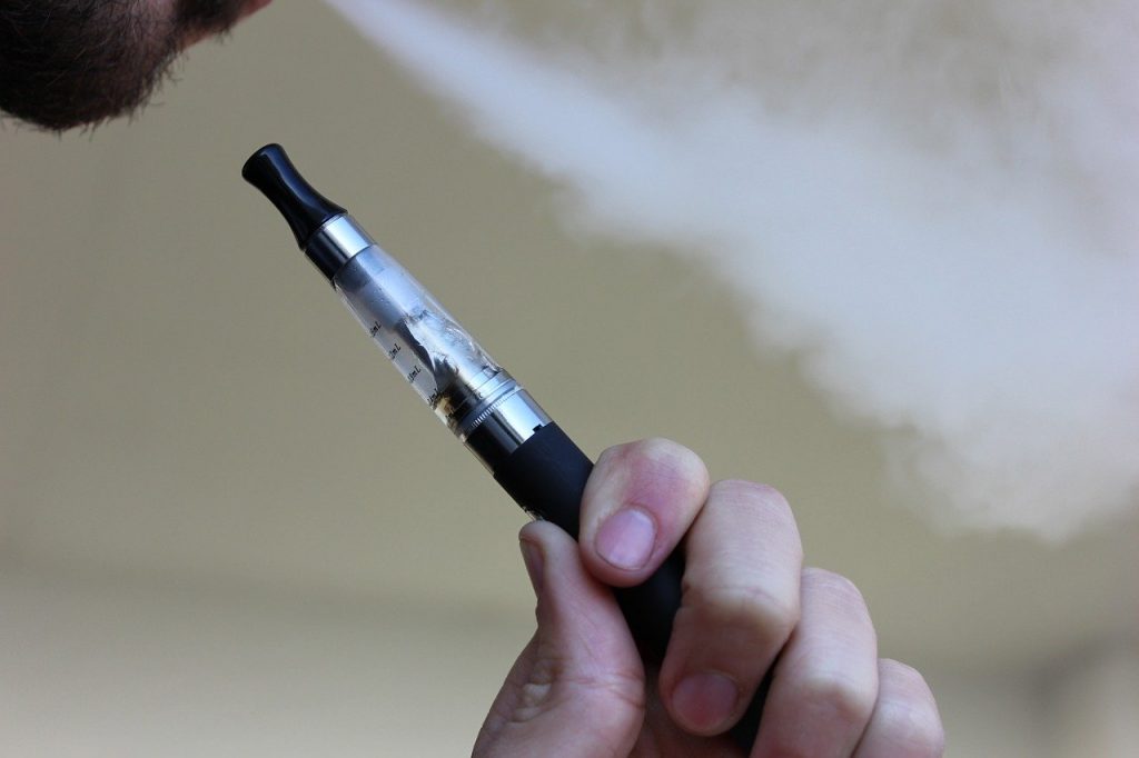 Man vaping using an e-cigarette.