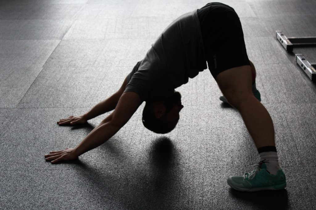 Man doing hip stretch on the floor.
