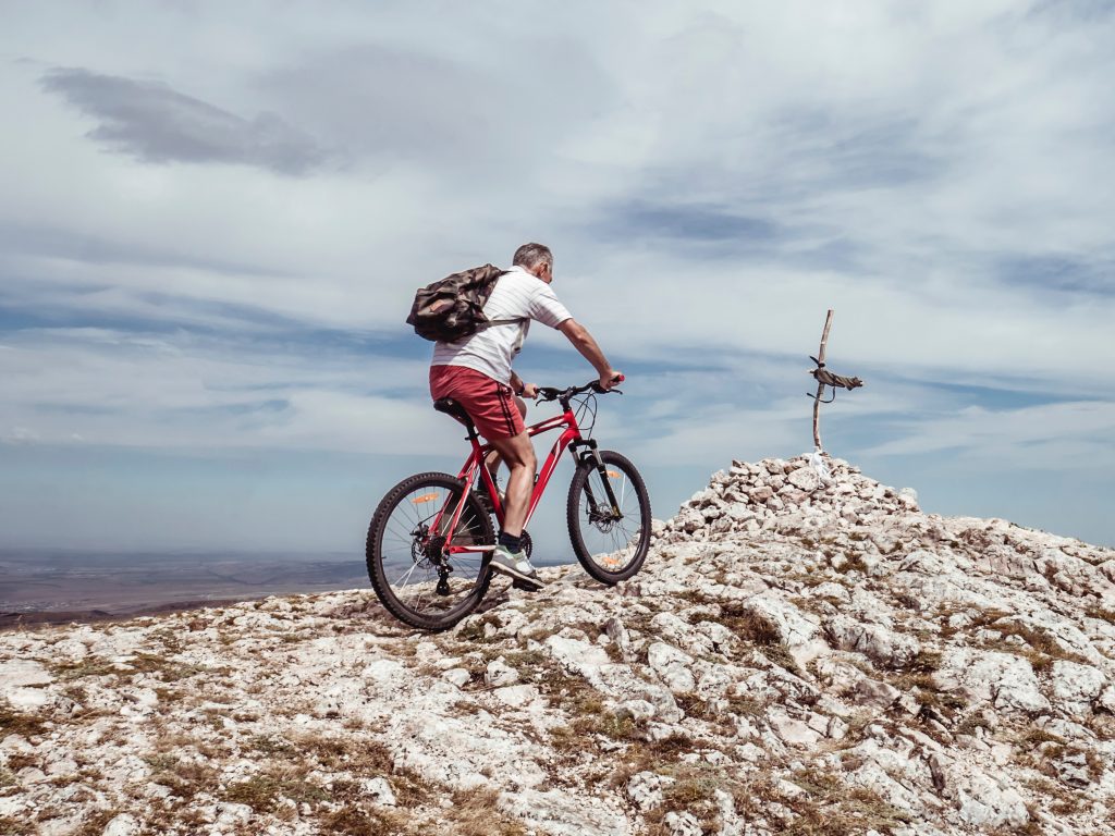 Man riding a bike in a hill.