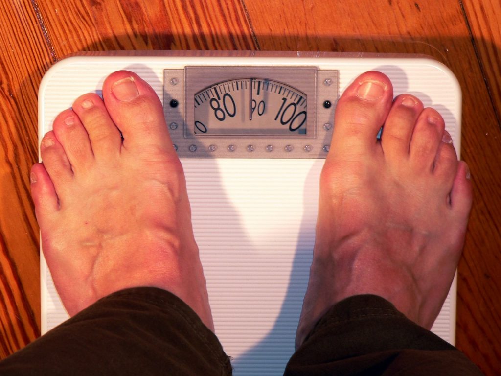 Person weighing on a bathroom scale.