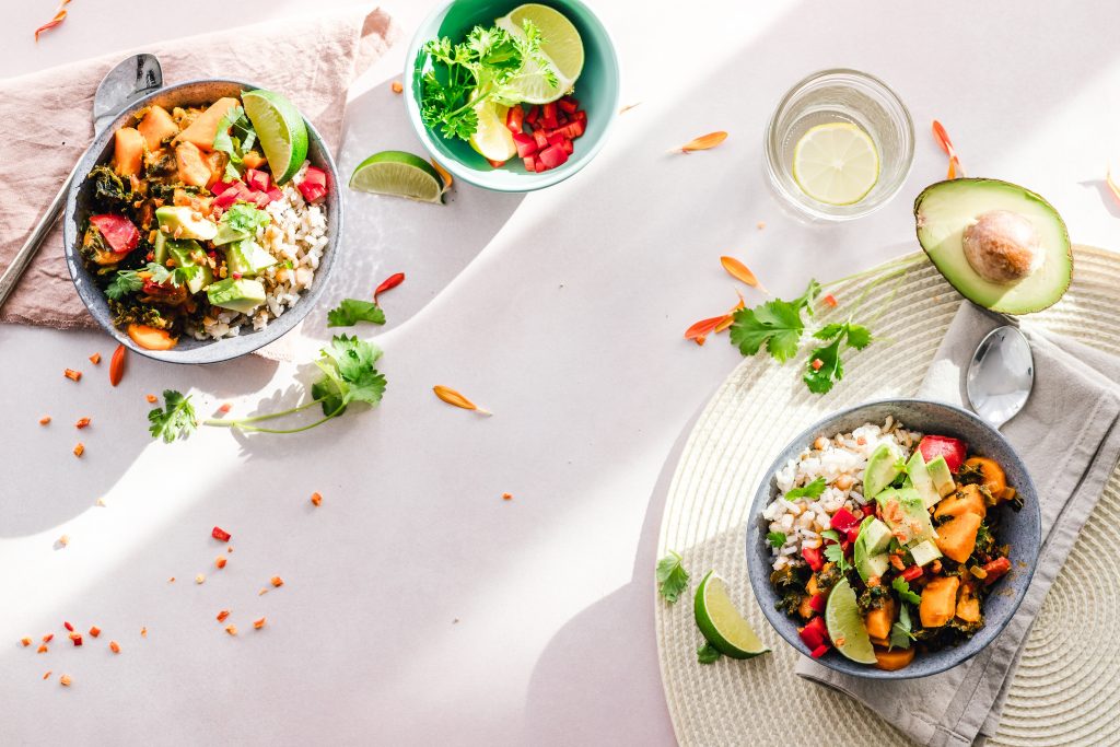Shot of two grain bowls on white table.