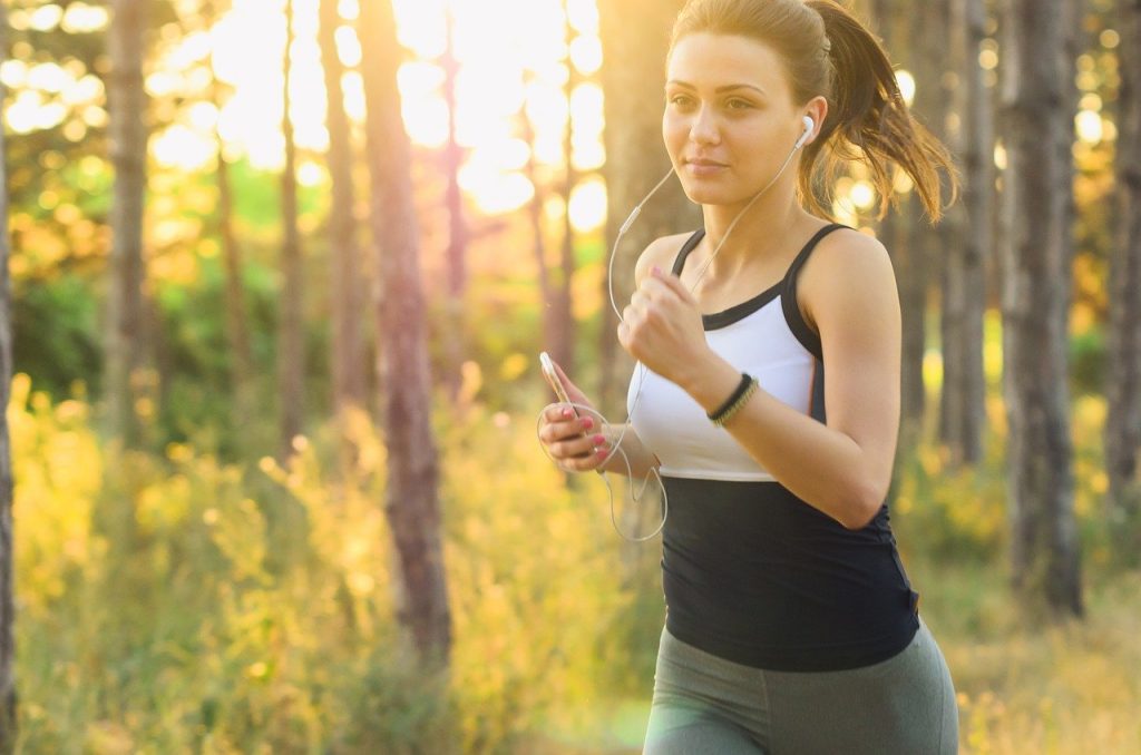 Fit woman running, to boost her mood. Which proves that exercise reduce anxiety.