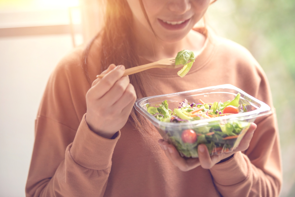 Woman eating a salad.