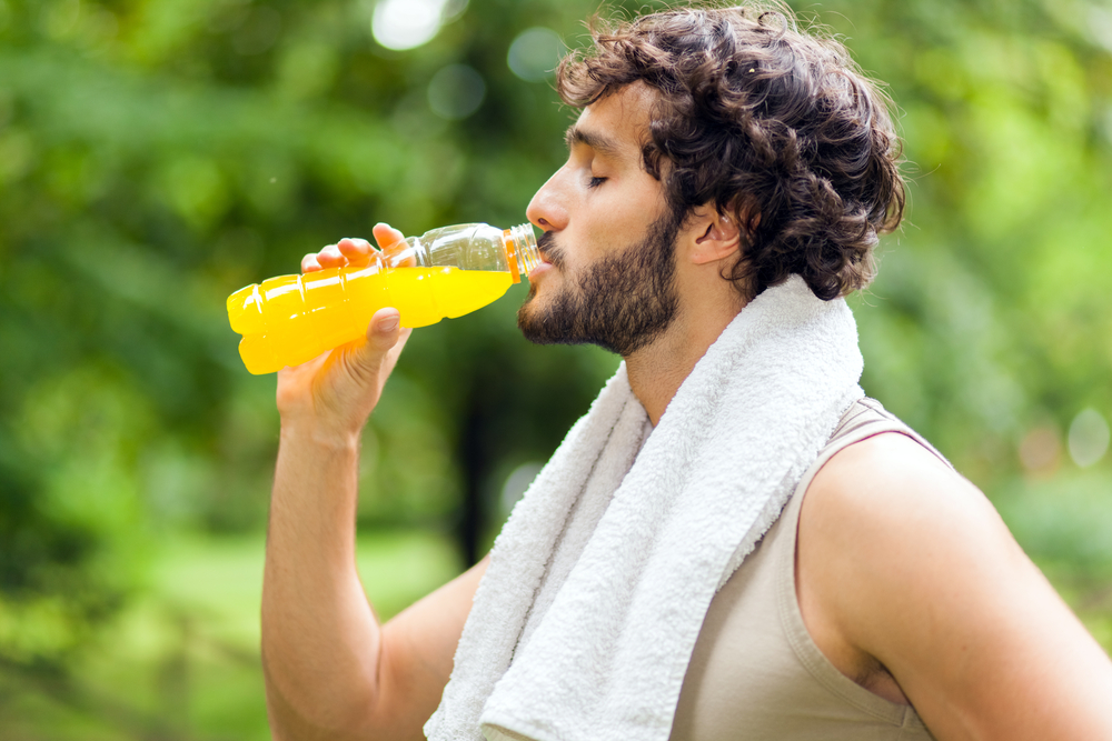 Young man drinking after sport