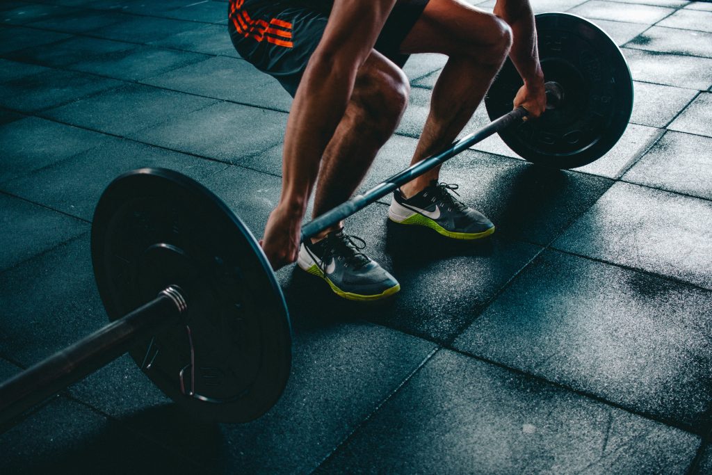 Man preparing to do a deadlift as an exercise for functional fitness.