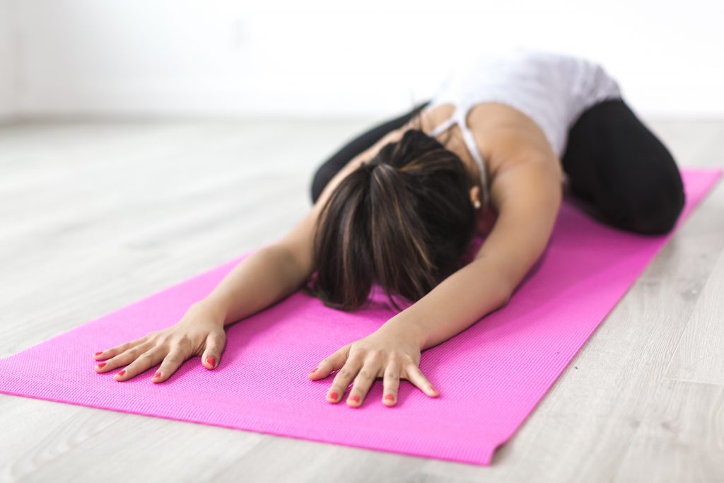 Woman stretching on a yoga mat.