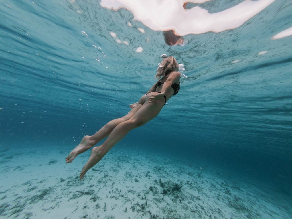 Woman swimming in the ocean as an exercise to reduce anxiety