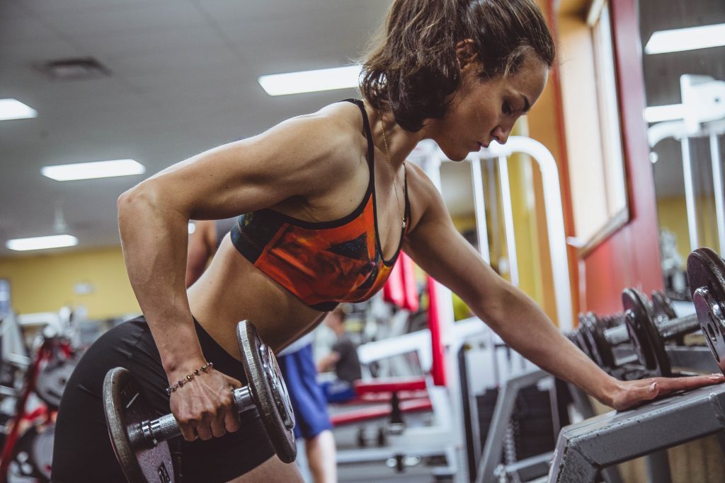 Fit woman lifting weights at the gym.