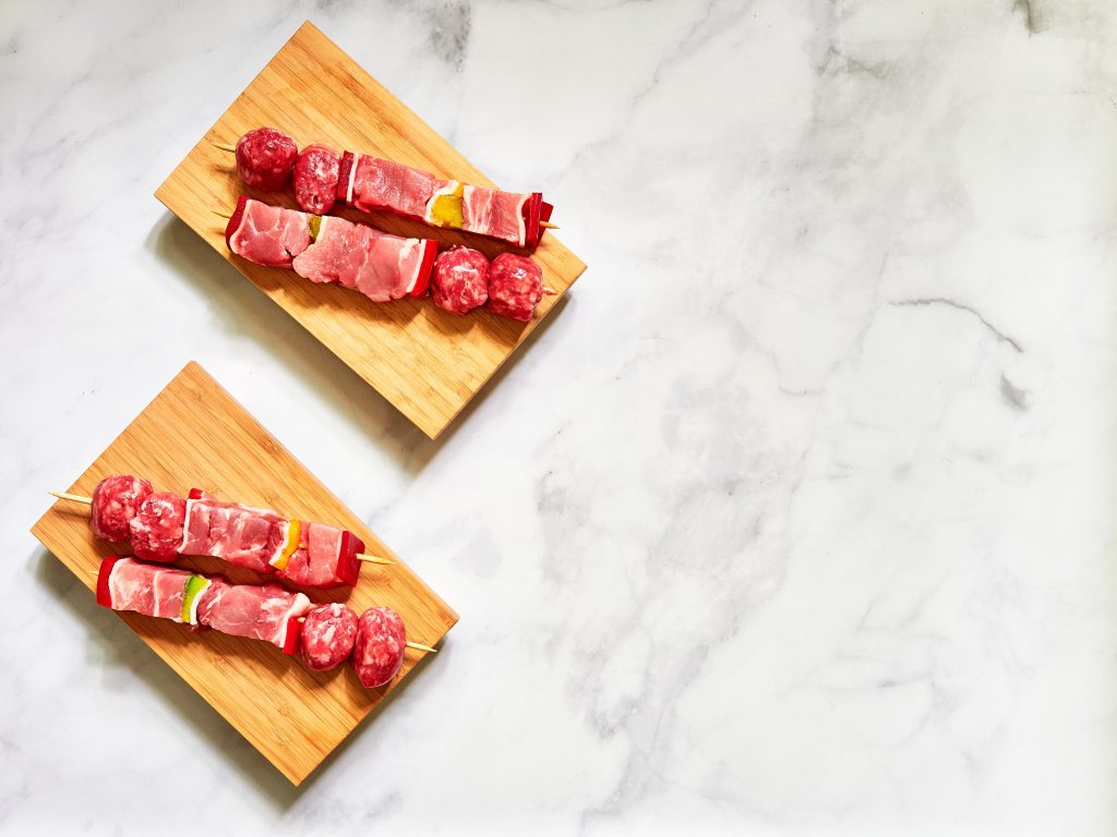 Assortment of red meat on a skewer on a table. Is red meat bad for you?