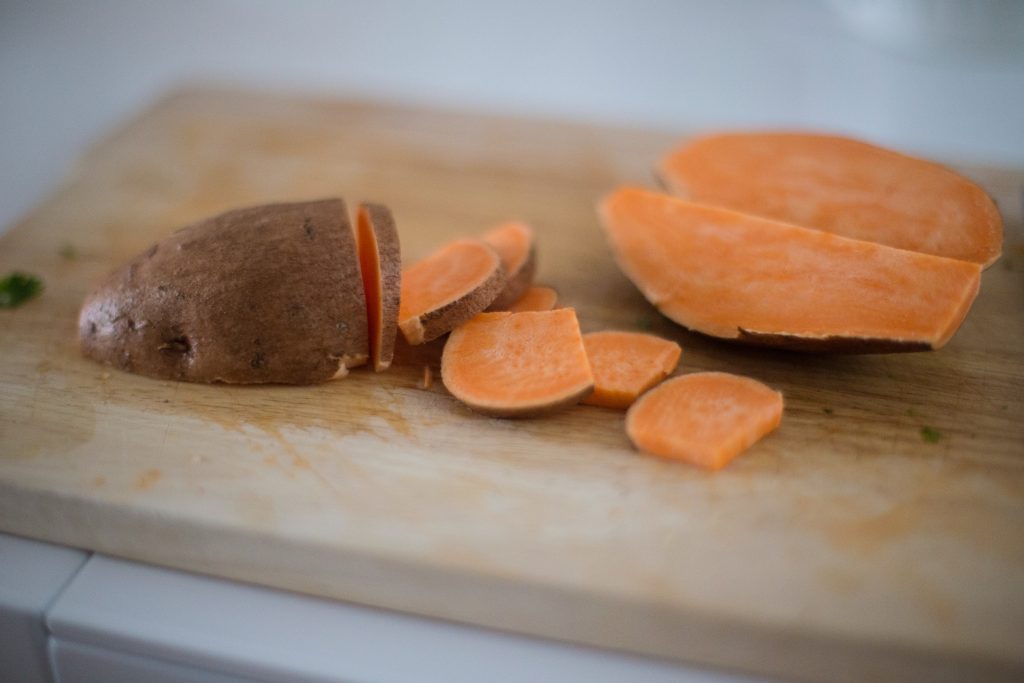 Sliced Sweet Potatoes on a cutting board.