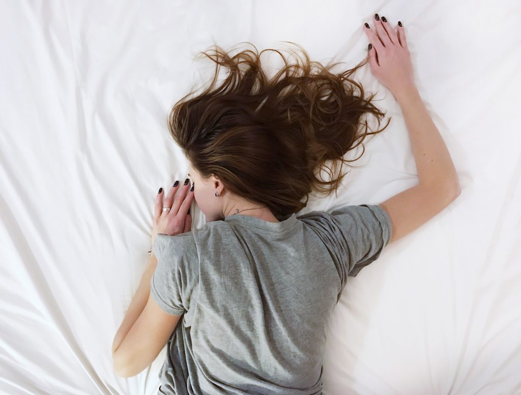 Woman sleeping soundly on a bed.