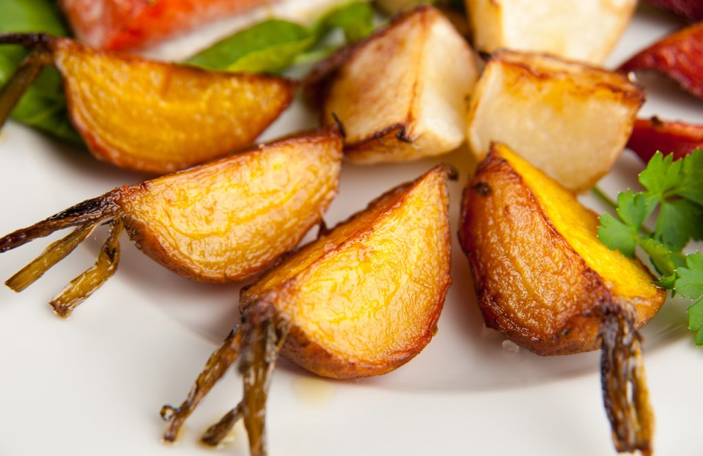 Carrot and turnip fries on a white plate make for a great lower calorie food.