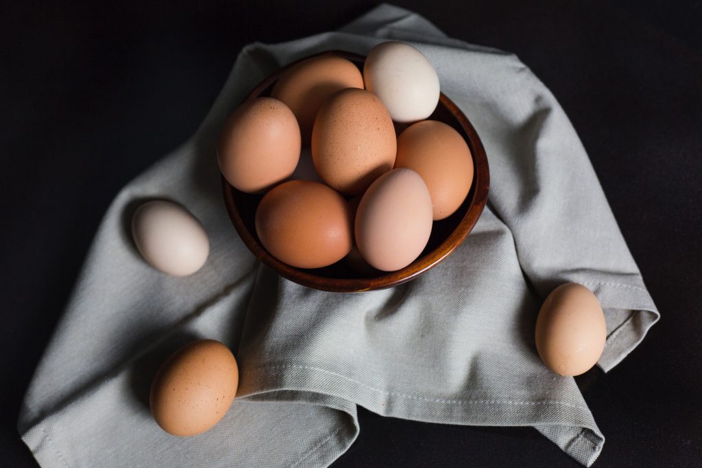 A tray of eggs on a black table.