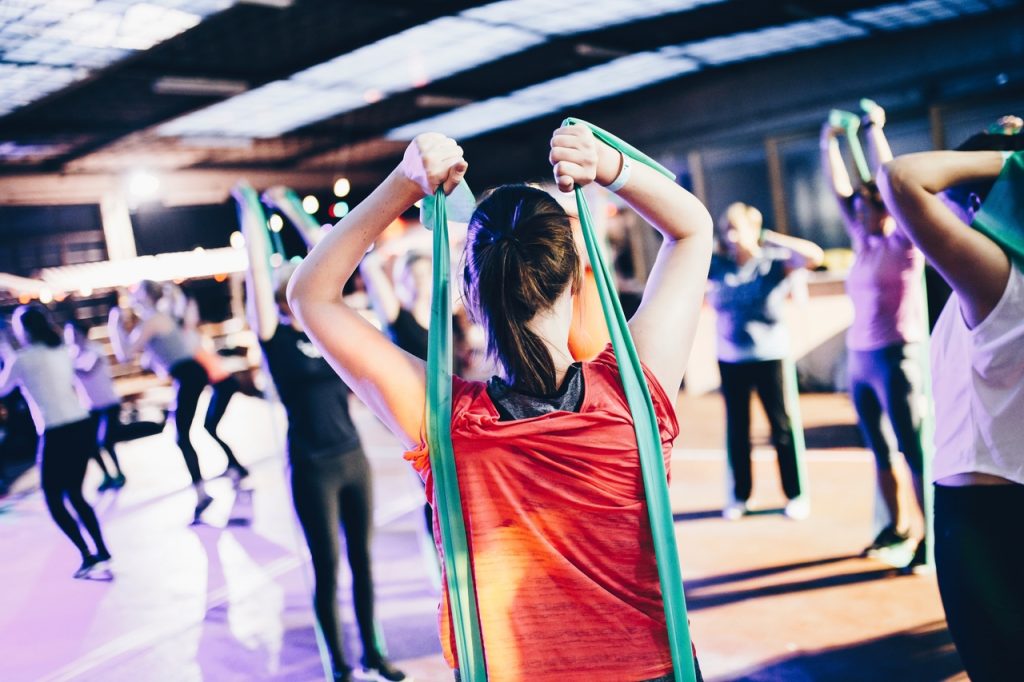 Fitness event, women doing some stretching and jump squats.