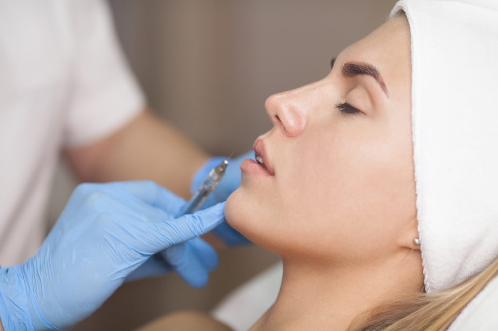 Beauty injections Close Up. Lip filler injection.