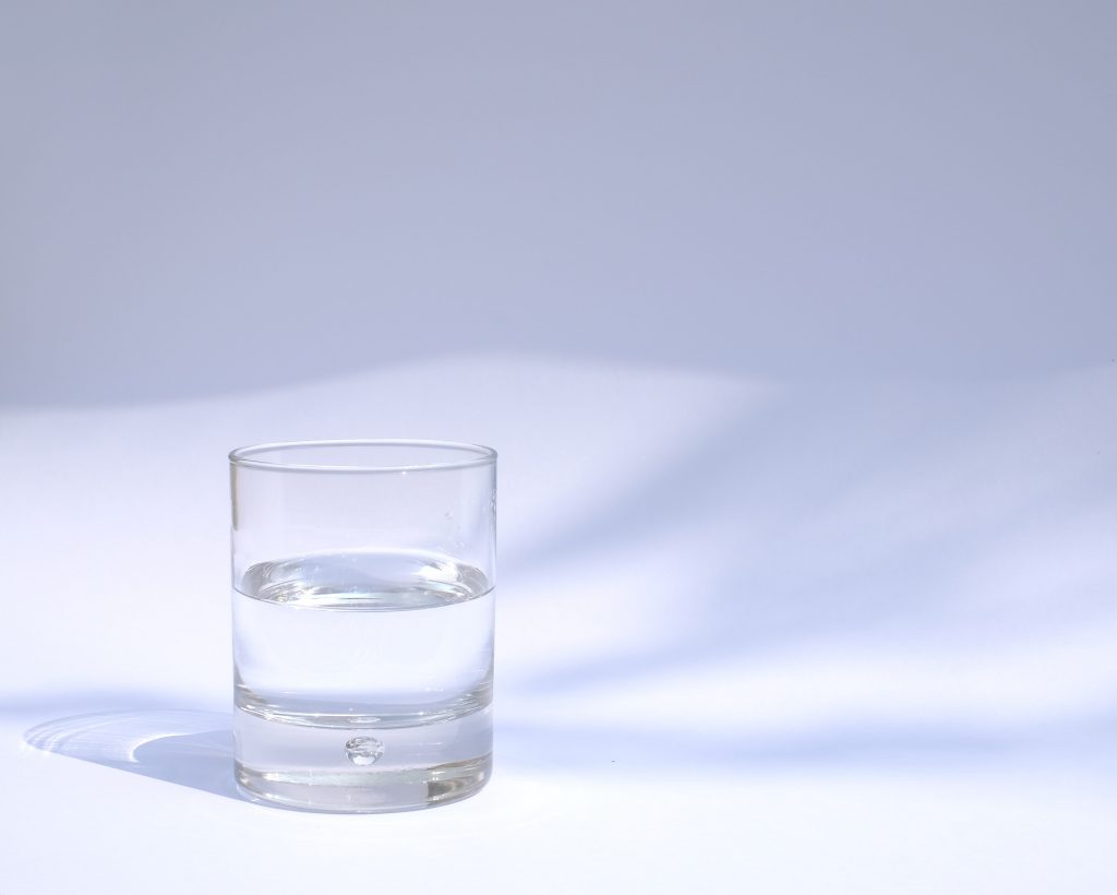 Glass of water to keep you hydrated as part of your muscle recovery foods.