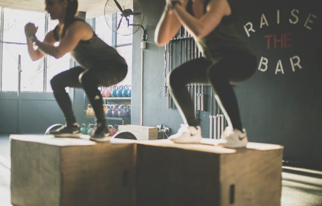 Two woman doing a knee exercise.