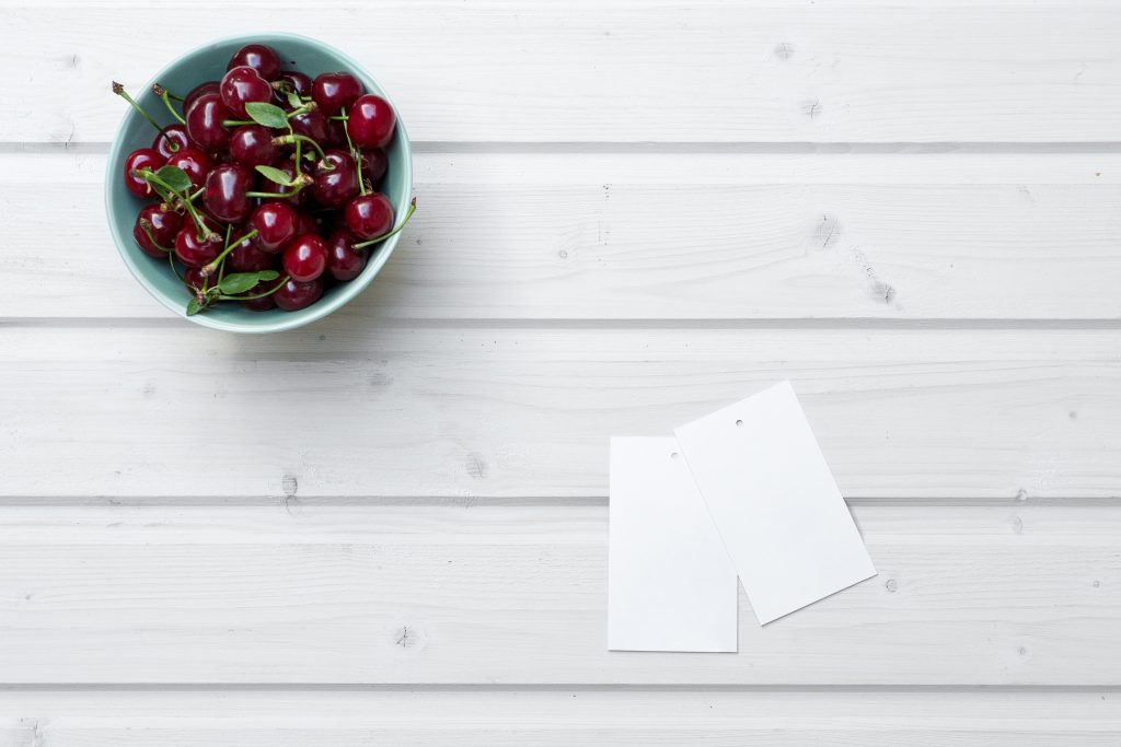 Bowl of cherries on a table.