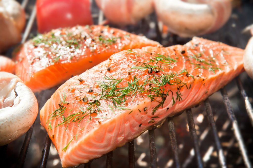 Salmon fillet on a barbecue grill is an example of protein.