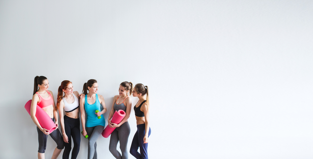 Group of friends having fun chatting after a workout.