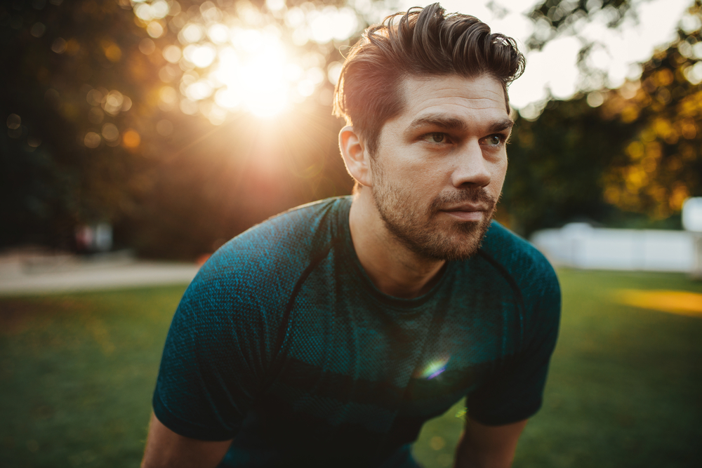 A man enjoying the nature while doing an early morning workout.