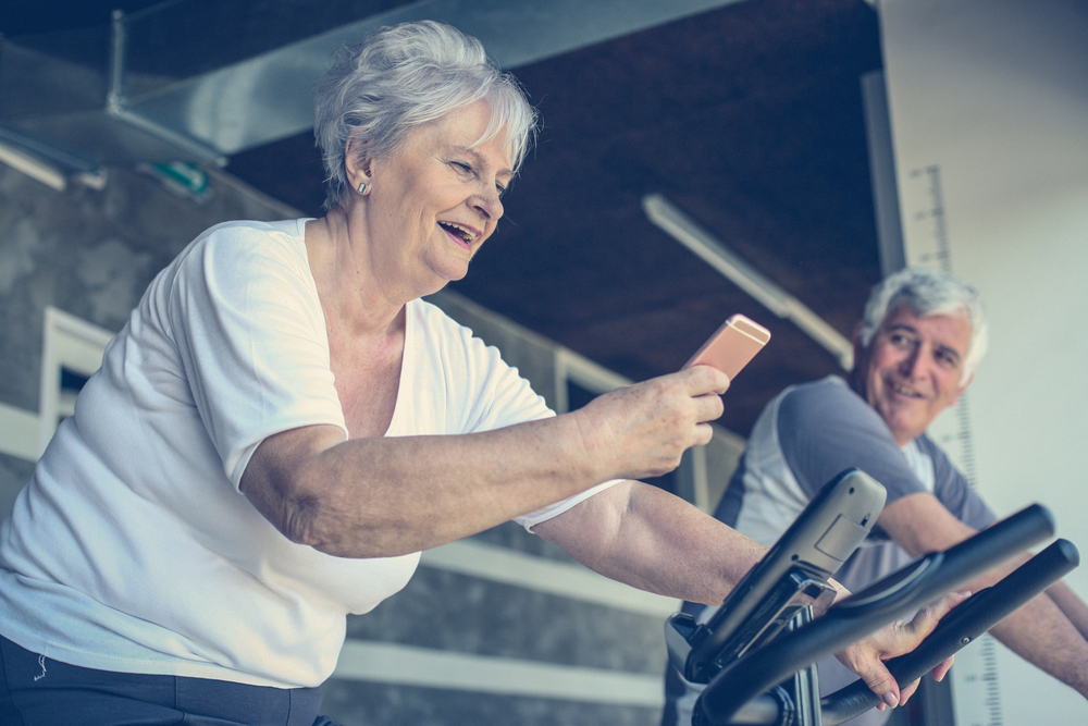 Veterans enjoying their workout while using a mobile phone.