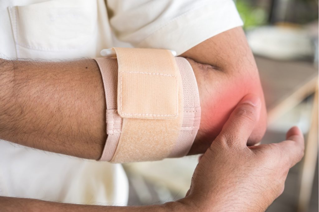 A man experiencing pain in his elbow needing an elbow bursitis treatment.