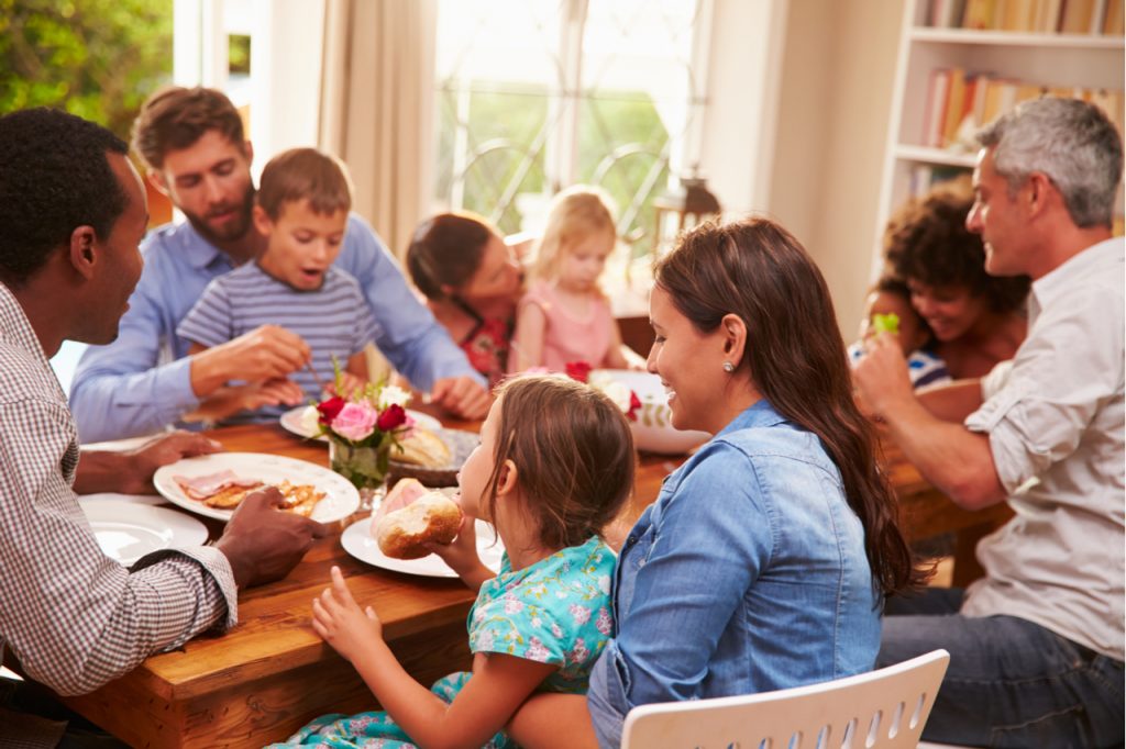 A woman having a meal with her whole family.