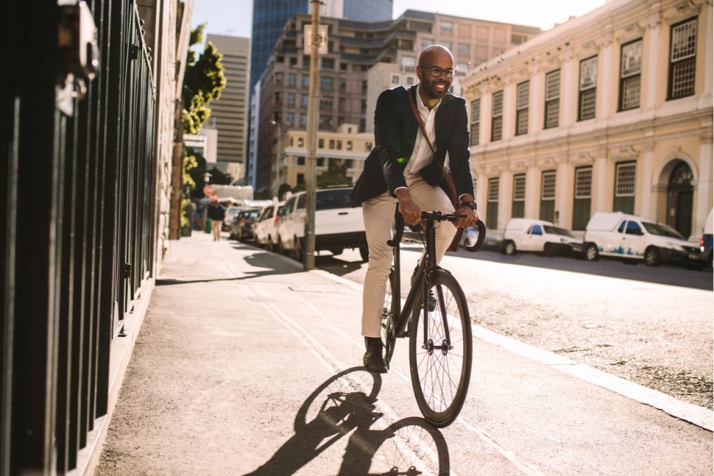 A man in a suit biking to work.