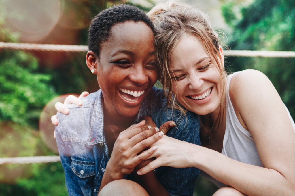 Friends of color laughing and having fun together.