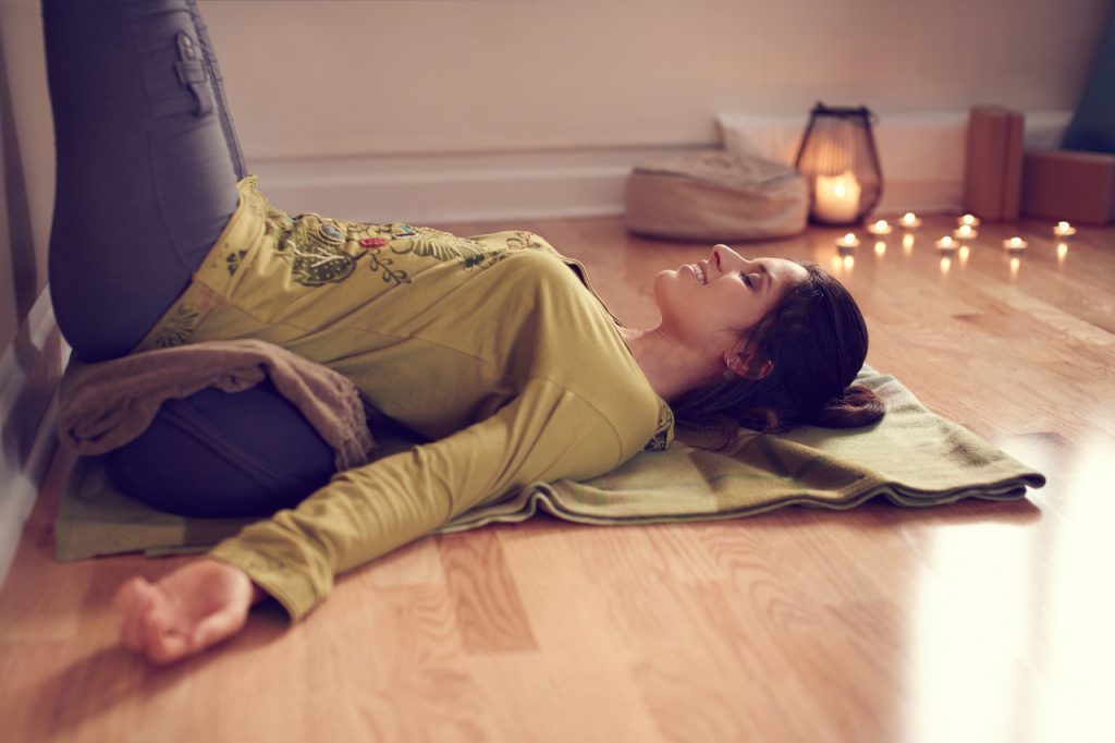A woman doing the legs up the wall pose.
