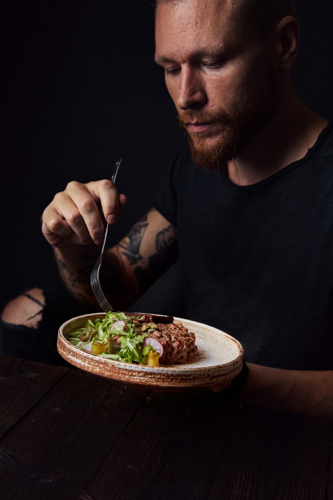 A man eating. The hunger hormones is being release by the body to make you aware that you haven't eaten in a while.