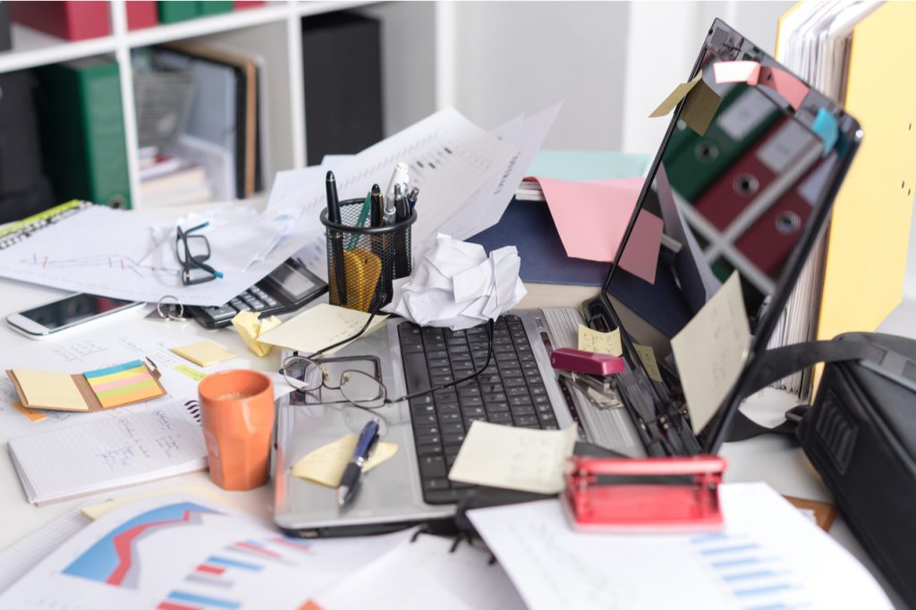 An image of a messy office desk that needs an organized office desk ideas.