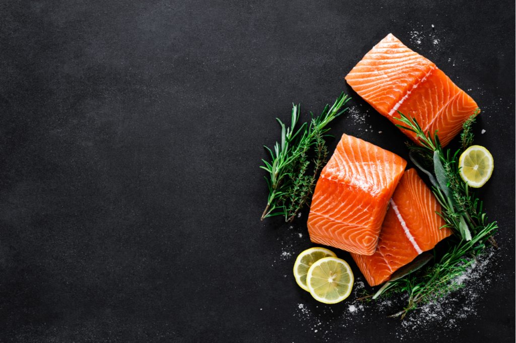 Salmon slices in a black background.