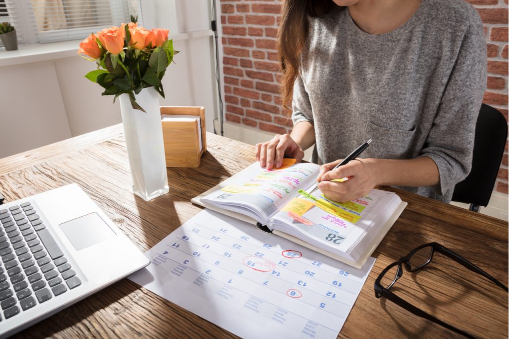 A woman making weekly schedule.