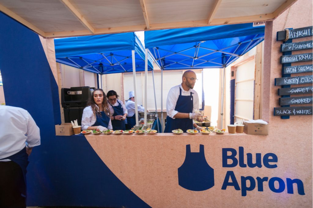 Blue Apron booth offering food.
